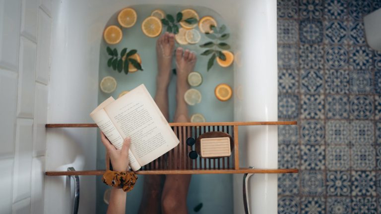 person holding book page on white table